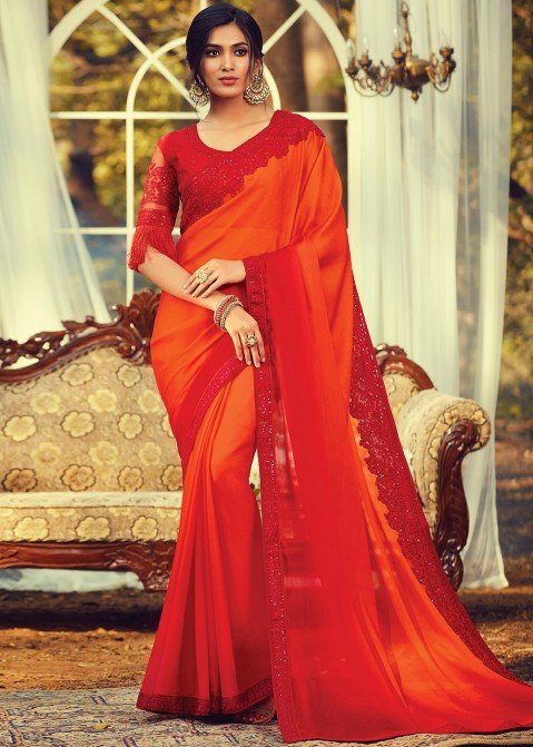 FIERY ORANGE TIE AND DYE 'ABLA' WORK CLASSIC SAREE PAIRED WITH A RED  EMBROIDERED BLOUSE AND SILVER HIGHLIGHTS. - Seasons India