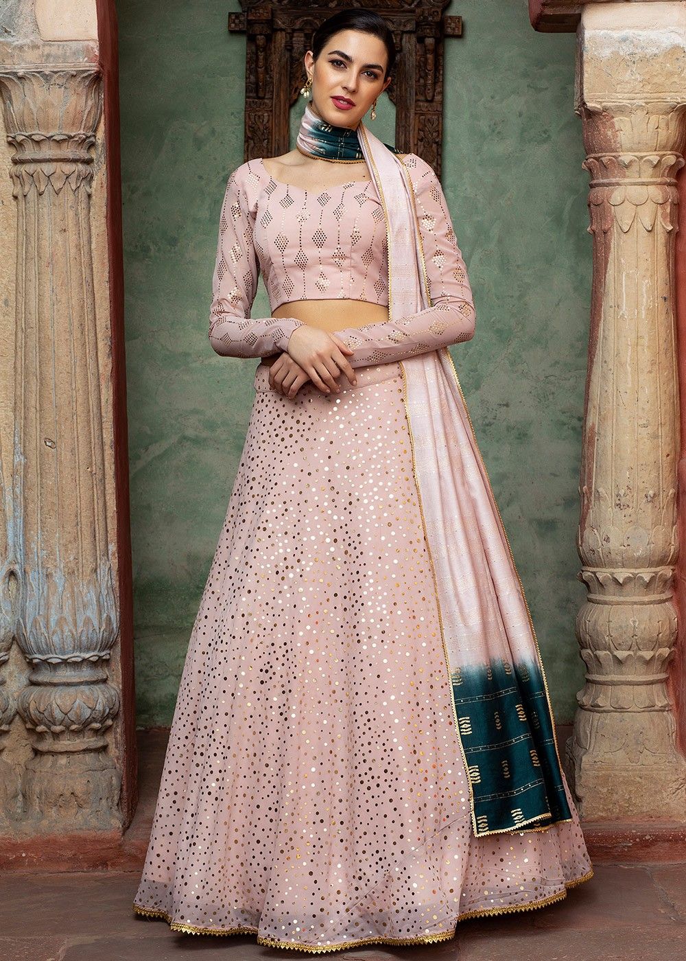 DUSTY PEACH LEHENGA SET WITH ALL OVER SILVER PATTERNED EMBROIDERY PAIRED  WITH A MATCHING DUPATTA AND TASSELS. - Seasons India