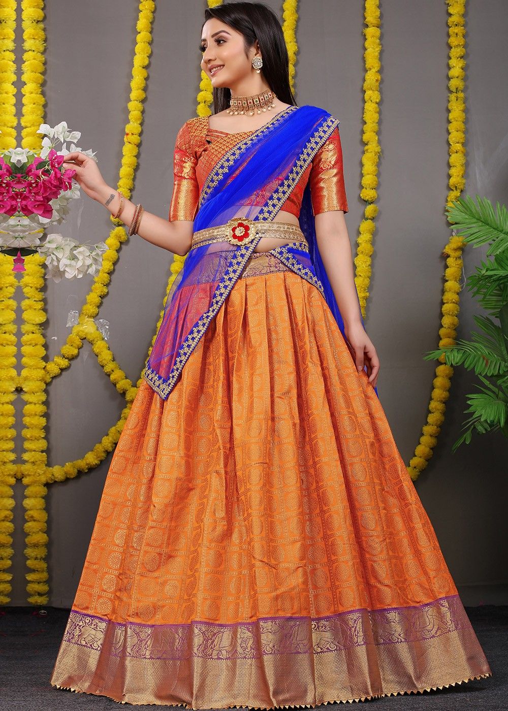 Stunning orange and bottle green color combination pattu langa voni. Blouse  with hand embroidery zardosi work.